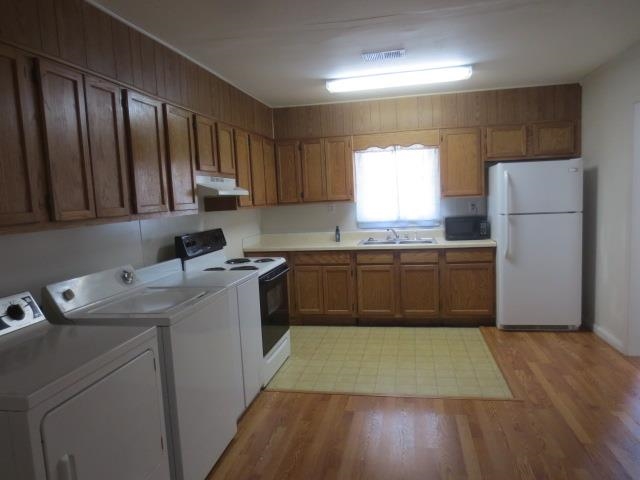 6386 Highway 209 Ripley, TN 38063 - Photo 16 of 23 a kitchen with a sink a stove a refrigerator and cabinets
