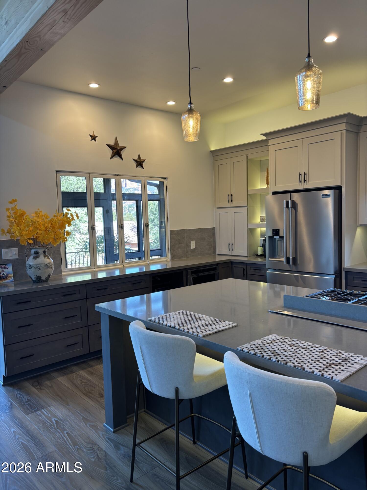10 Granada Road Sedona, AZ 86336 - Photo 14 of 28 a kitchen with a dining table chairs stainless steel appliances and cabinets