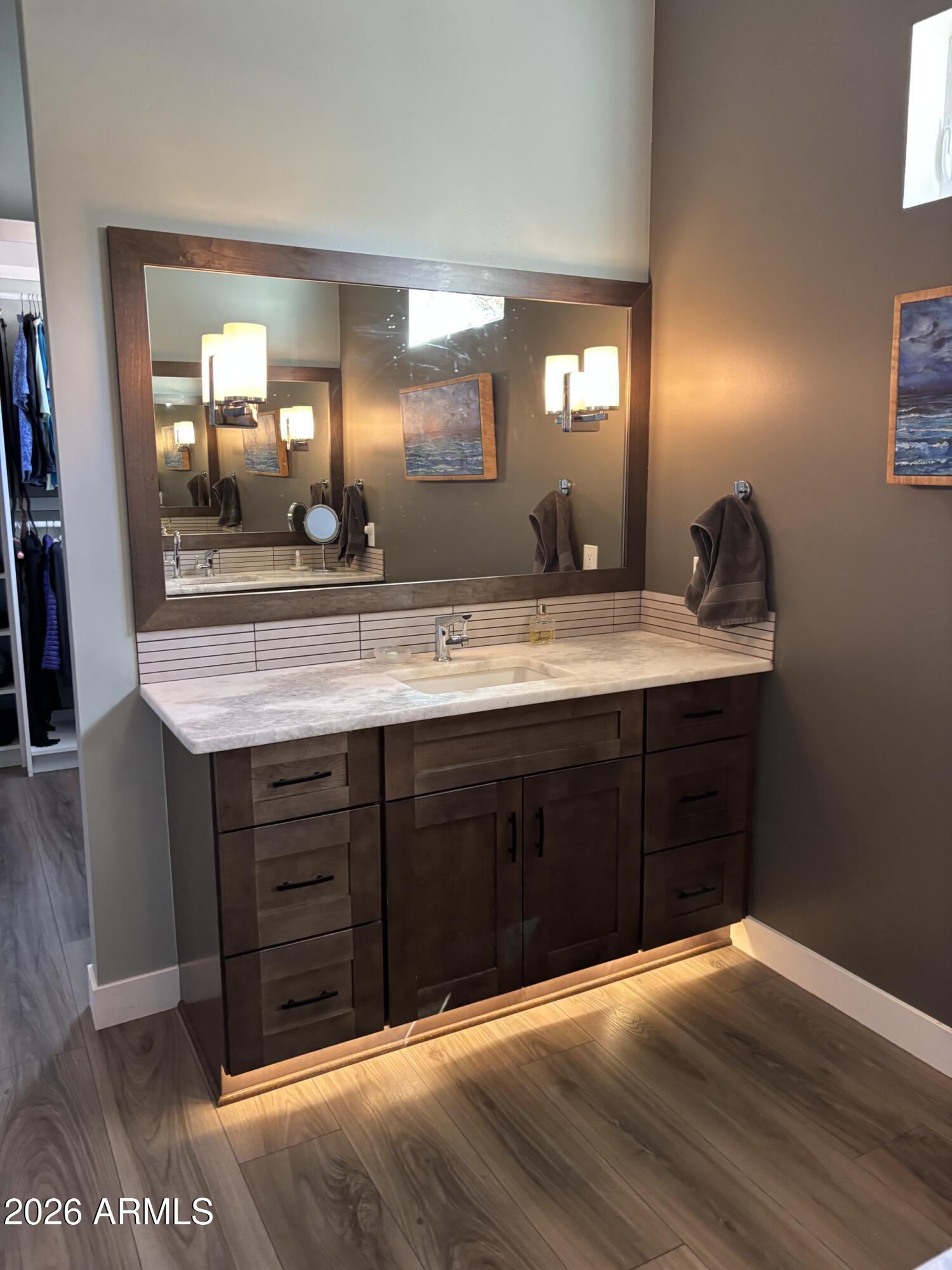 10 Granada Road Sedona, AZ 86336 - Photo 26 of 28 a spacious bathroom with a granite countertop sink and a mirror