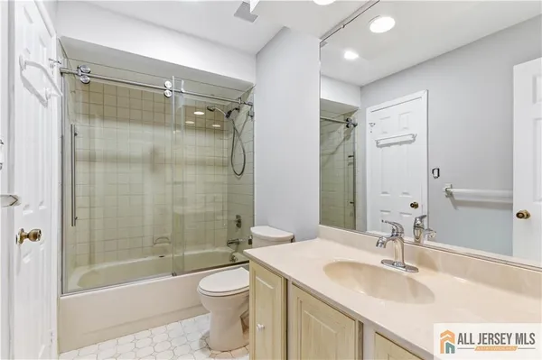 a bathroom with a sink mirror toilet and bathtub