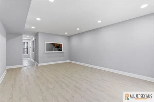 an empty room with a empty space and windows