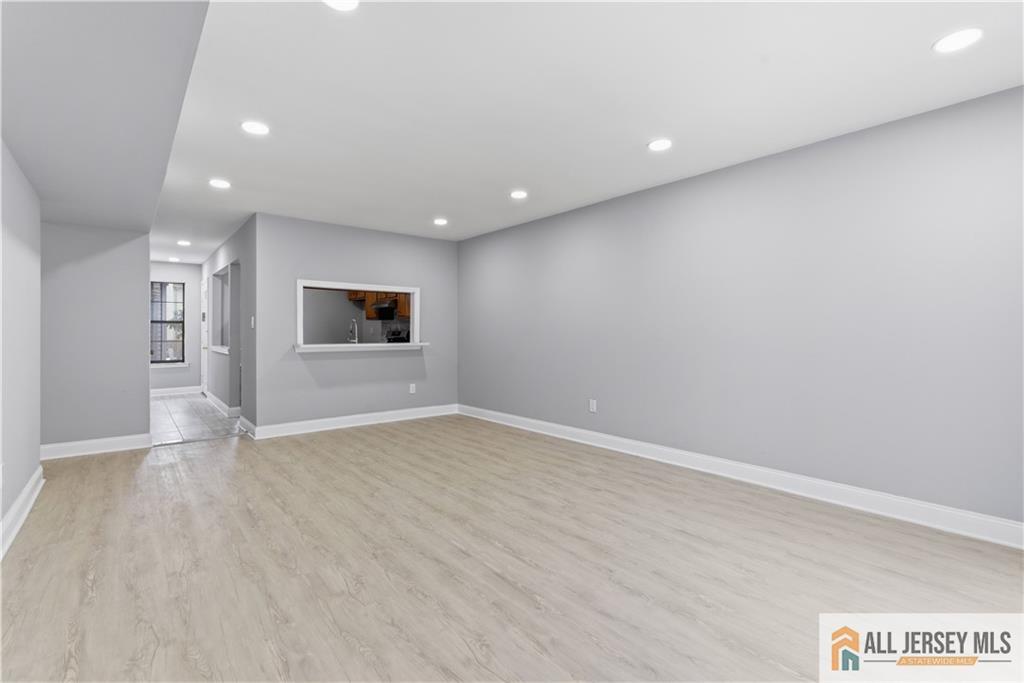 809 Woodbridge Commons Way, Unit 809 Iselin, NJ 08830 - Photo 6 of 16 an empty room with a empty space and windows