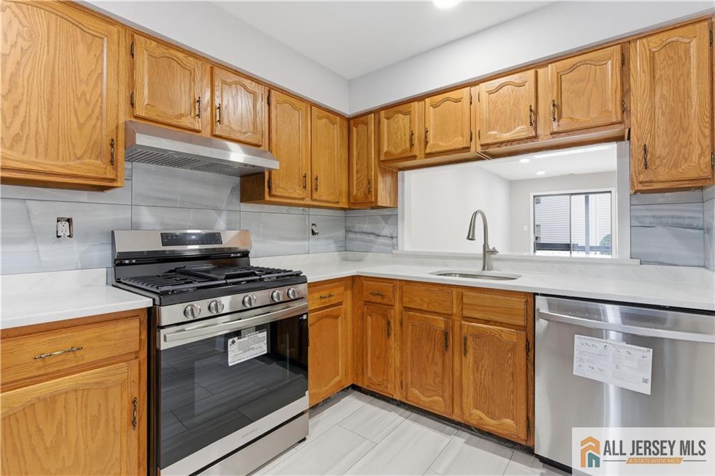 809 Woodbridge Commons Way, Unit 809 Iselin, NJ 08830 - Photo 7 of 16 a kitchen with stainless steel appliances granite countertop a stove and a sink