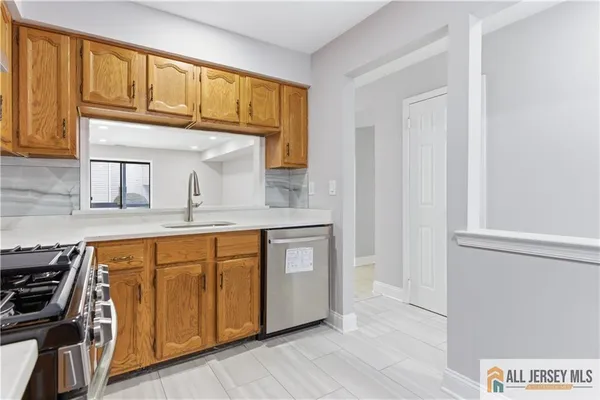 a kitchen with stainless steel appliances granite countertop a stove and a sink