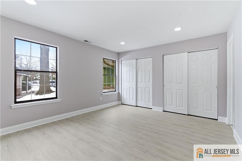 809 Woodbridge Commons Way, Unit 809 Iselin, NJ 08830 - Photo 10 of 16 a view of an empty room with a window