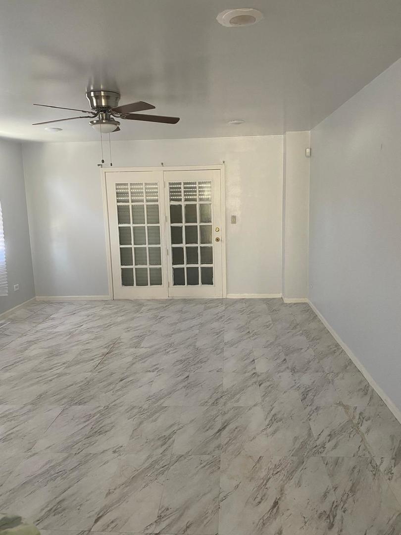60 East 91st Street Chicago, IL 60619 - Photo 2 of 4 an empty room with wooden floor and windows