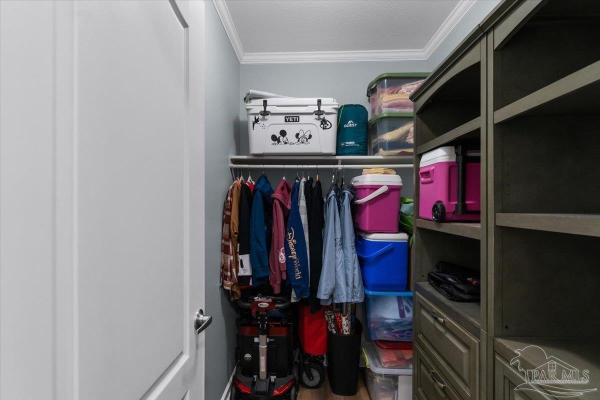 4955 Blue Ribbon Drive Milton, FL 32583 - Photo 15 of 32 a view of walk in closet with clothes and shoes