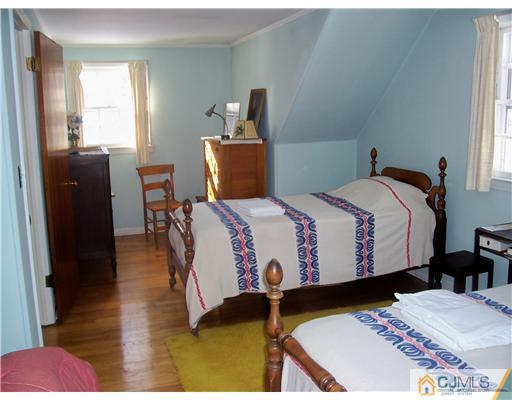 53 Copper Mine Road Princeton, NJ 08540 - Photo 8 of 17 a bedroom with a bed and wooden floor