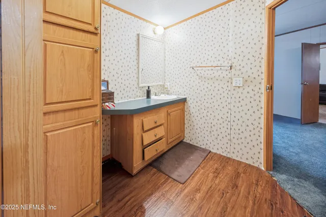 a bathroom with a sink a mirror and shower