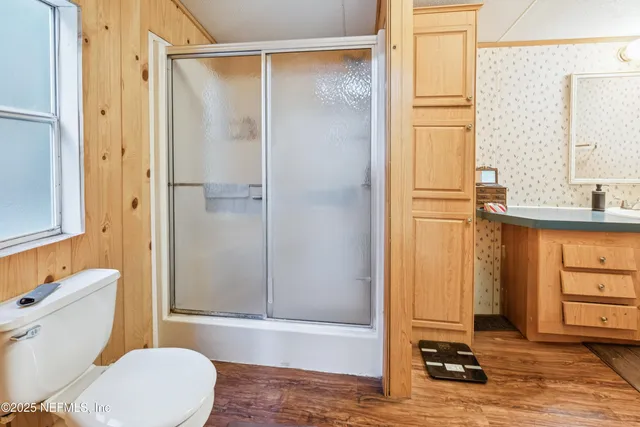 a bathroom with a sink toilet and shower