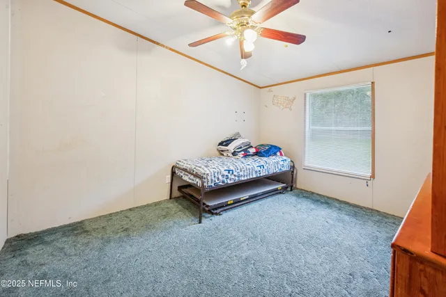 a living room with furniture and a baby crib