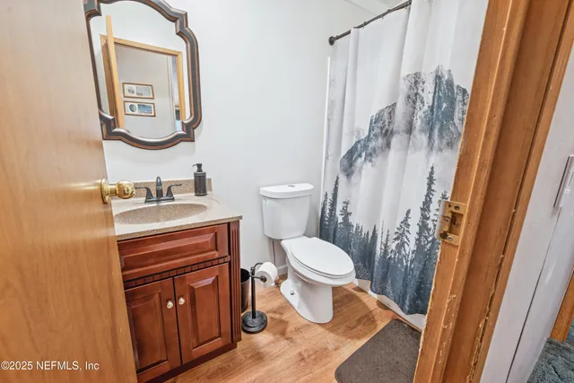 a bathroom with a toilet a sink and a mirror
