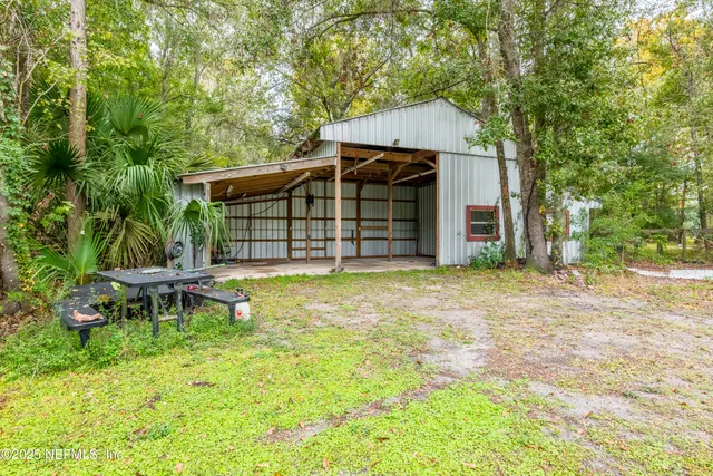 a front view of a house with a garden and patio