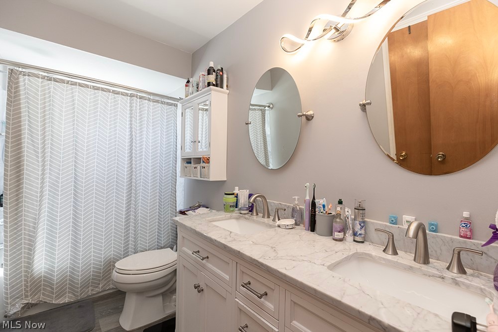 762 Abbe Road North Elyria, OH 44035 - Photo 30 of 30 Dual vanity featuring white cabinetry, marble-finish countertop, and brushed nickel hardware