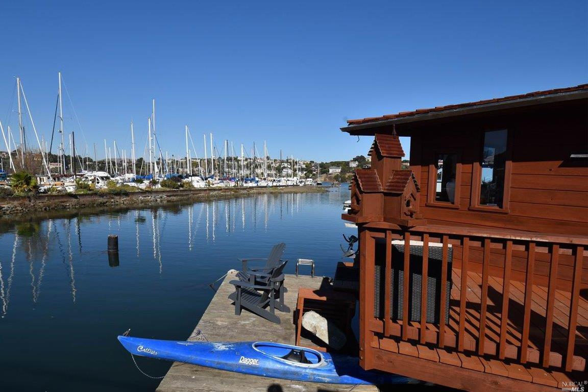 a view of a balcony with chairs and wooden floor