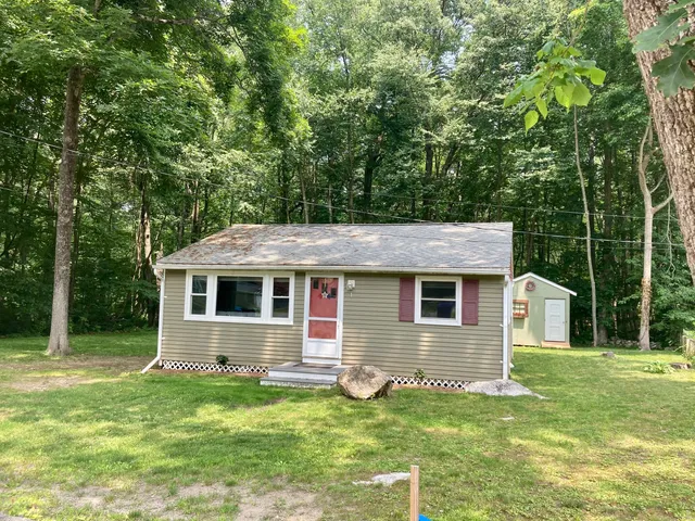 a front view of house with yard and green space