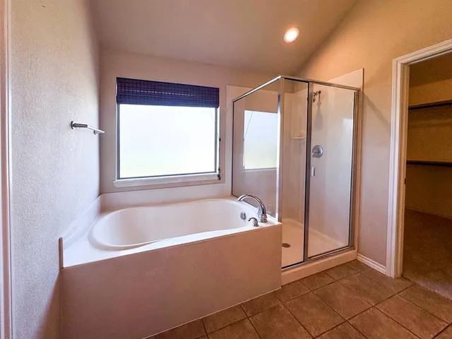 a bathroom with a bathtub and a shower