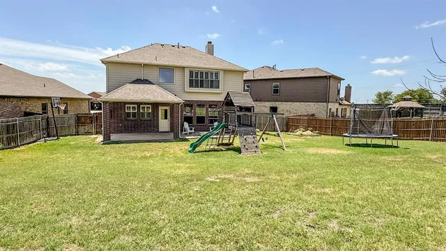a view of a swimming pool with a table and chairs under an umbrella