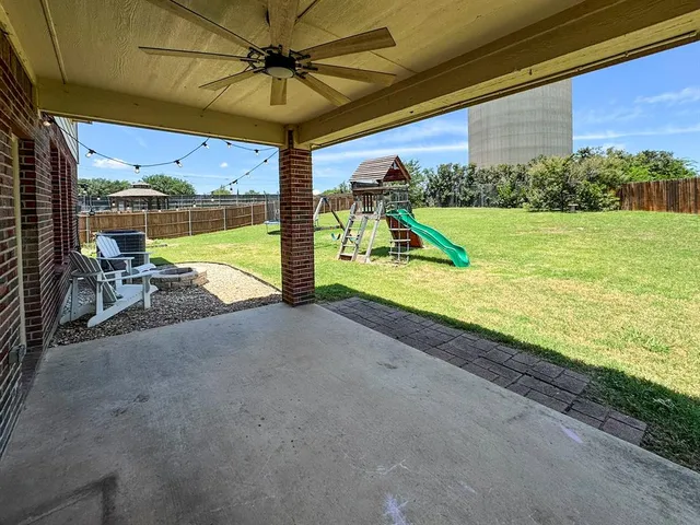 a view of roof deck with chair and table
