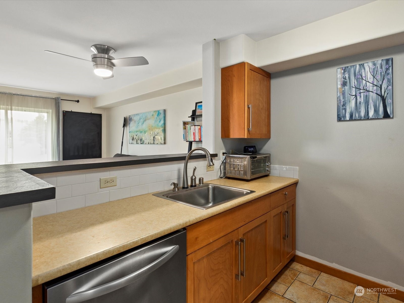 3015 Southwest Avalon Way, Unit 407 Seattle, WA 98126 - Photo 11 of 27 a kitchen with a sink and a refrigerator