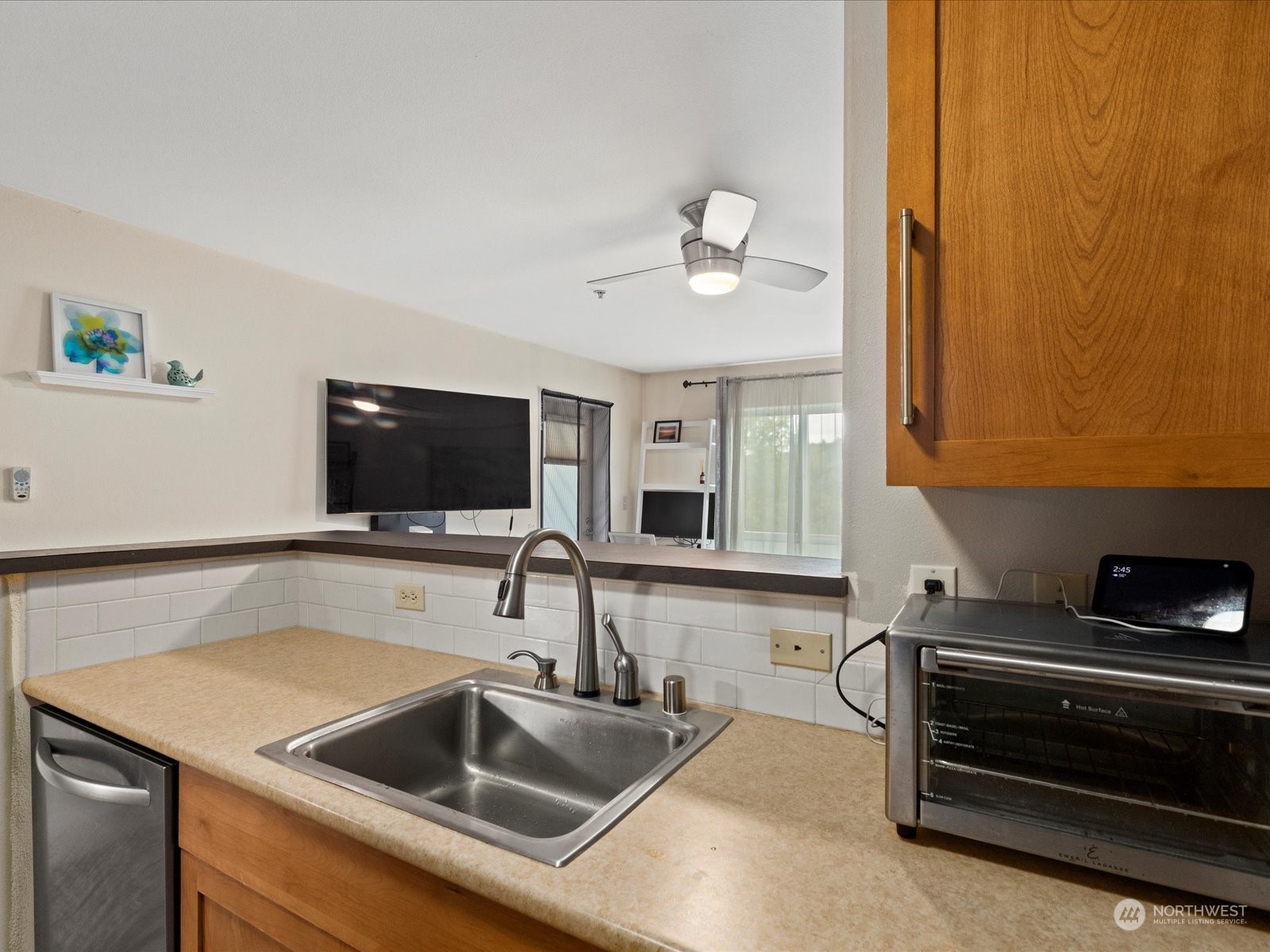 3015 Southwest Avalon Way, Unit 407 Seattle, WA 98126 - Photo 12 of 27 a kitchen with a sink and a refrigerator