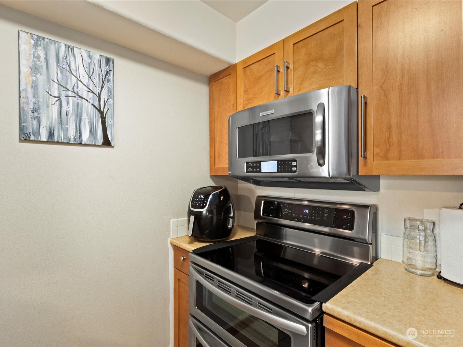 3015 Southwest Avalon Way, Unit 407 Seattle, WA 98126 - Photo 13 of 27 a kitchen with a stove and a microwave