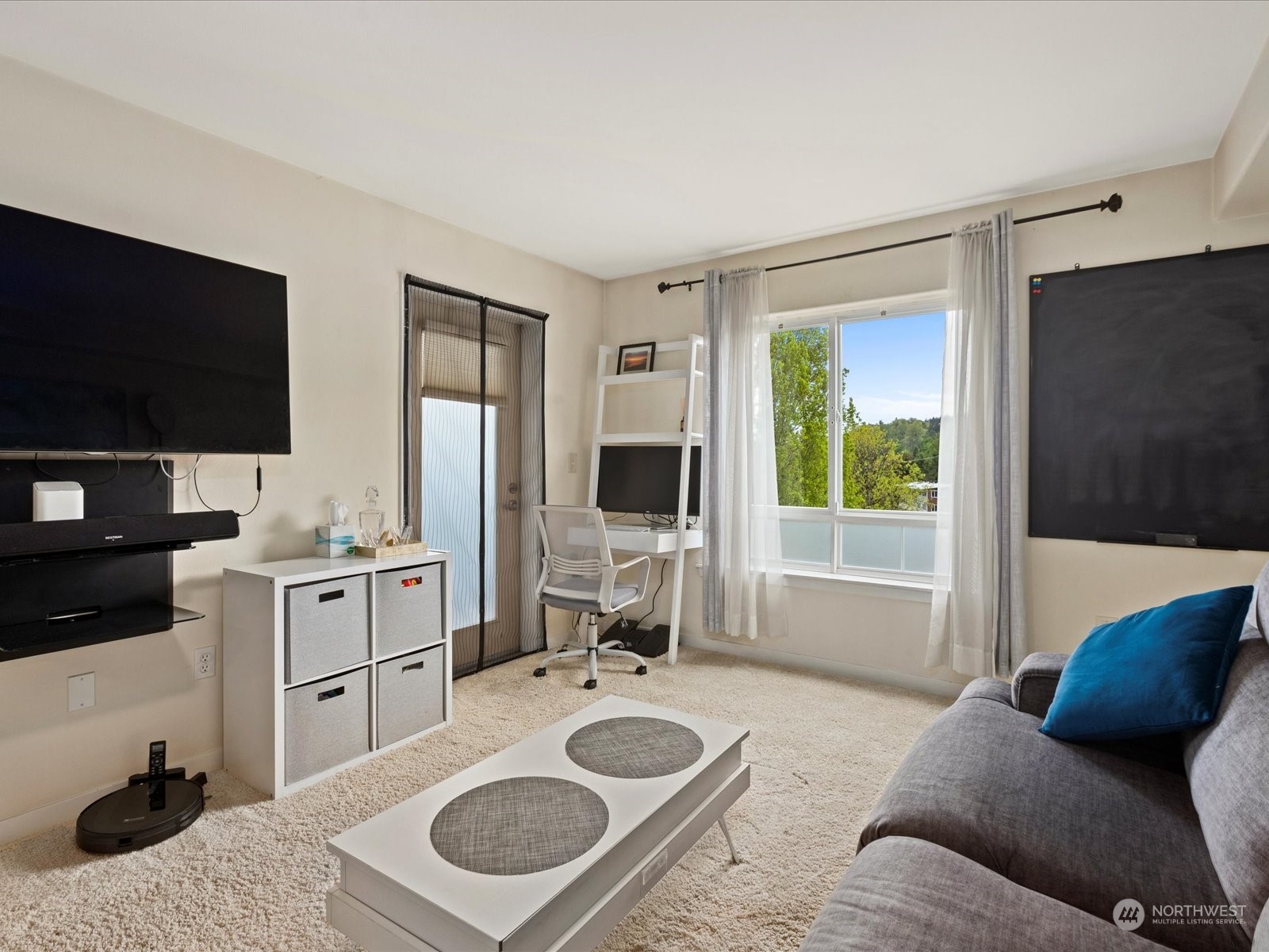 3015 Southwest Avalon Way, Unit 407 Seattle, WA 98126 - Photo 16 of 27 a living room with furniture and a flat screen tv