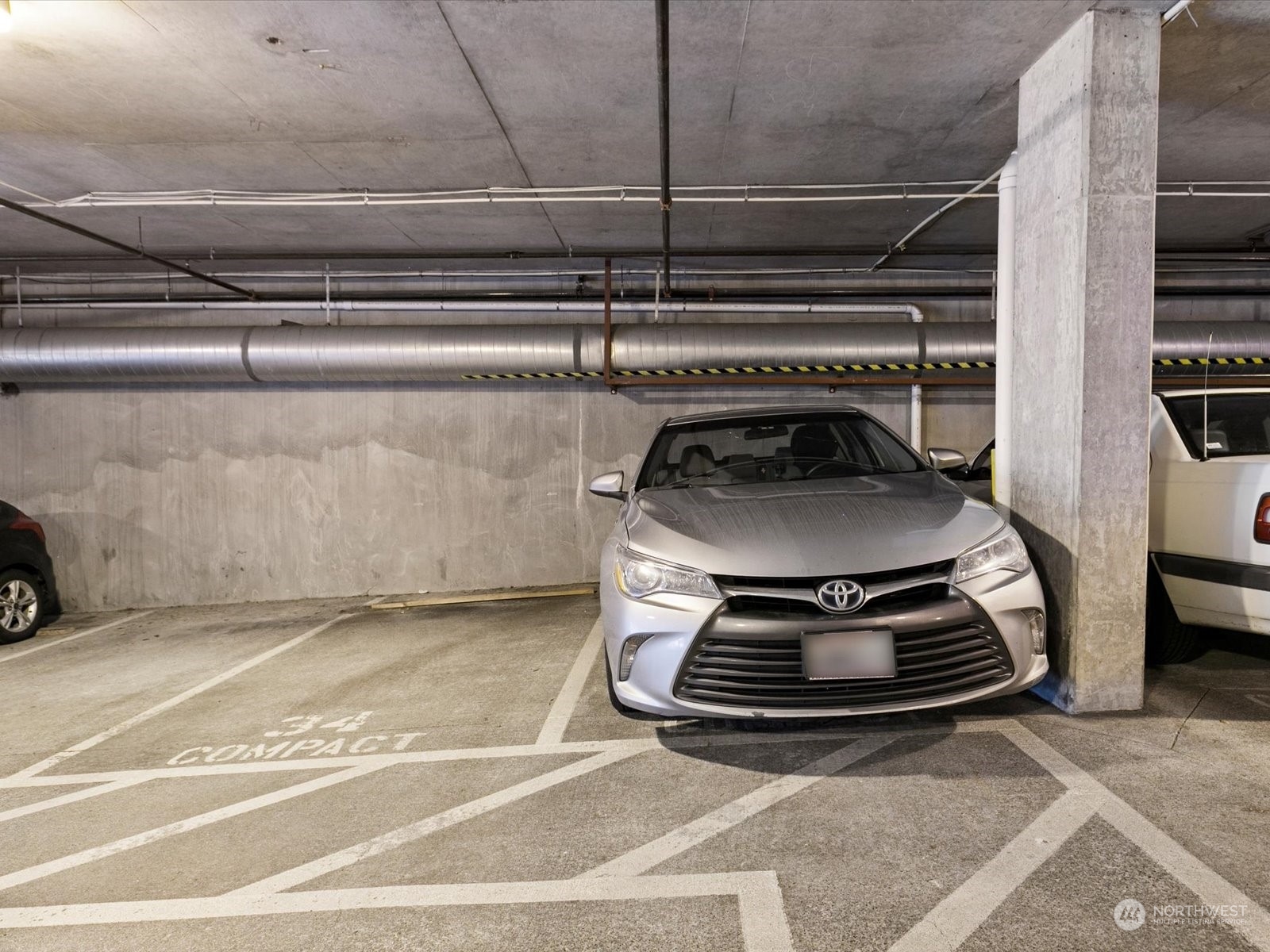 3015 Southwest Avalon Way, Unit 407 Seattle, WA 98126 - Photo 23 of 27 a stove top oven sitting inside of a kitchen