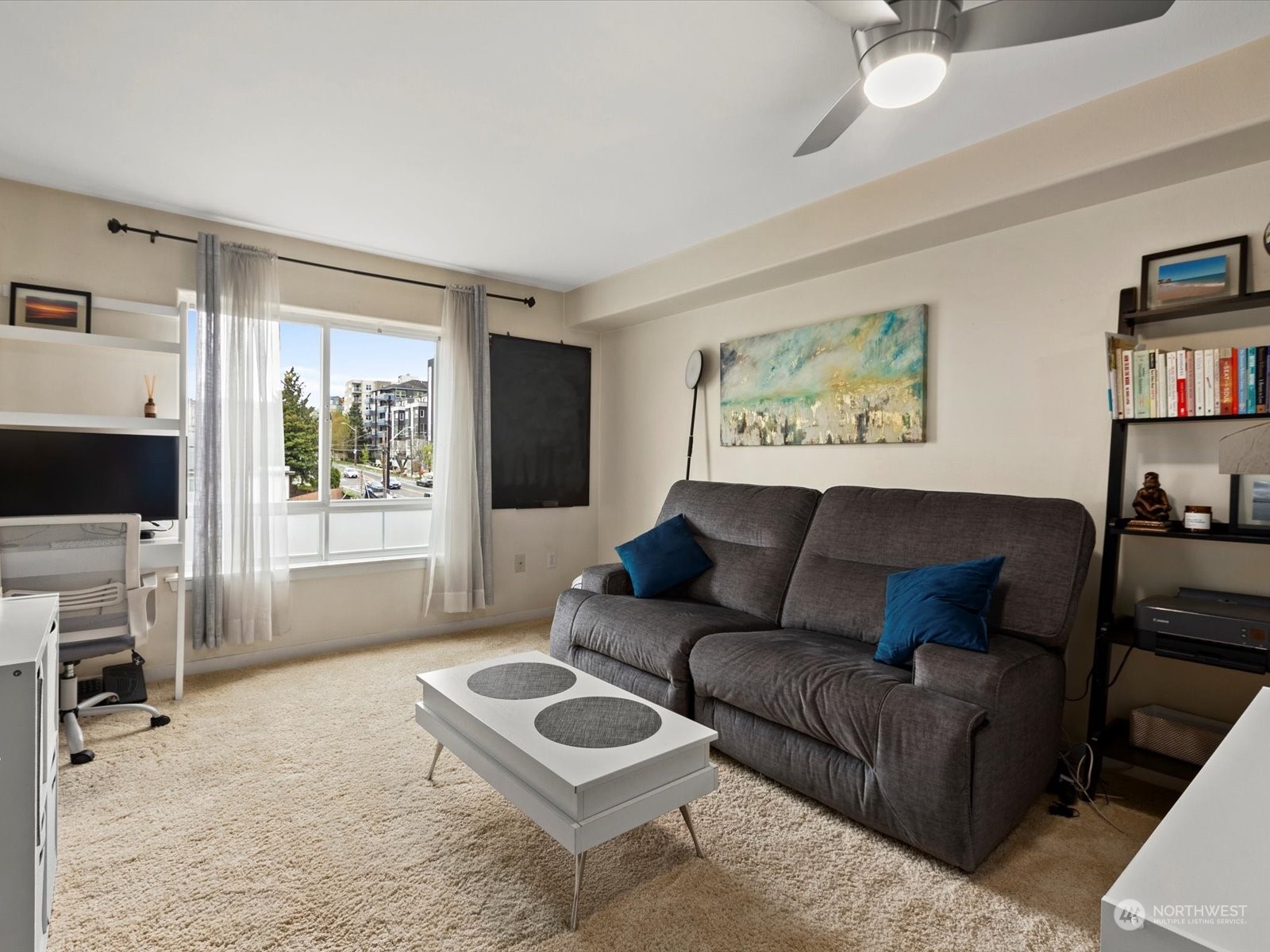 3015 Southwest Avalon Way, Unit 407 Seattle, WA 98126 - Photo 3 of 27 a living room with furniture a flat screen tv and a window