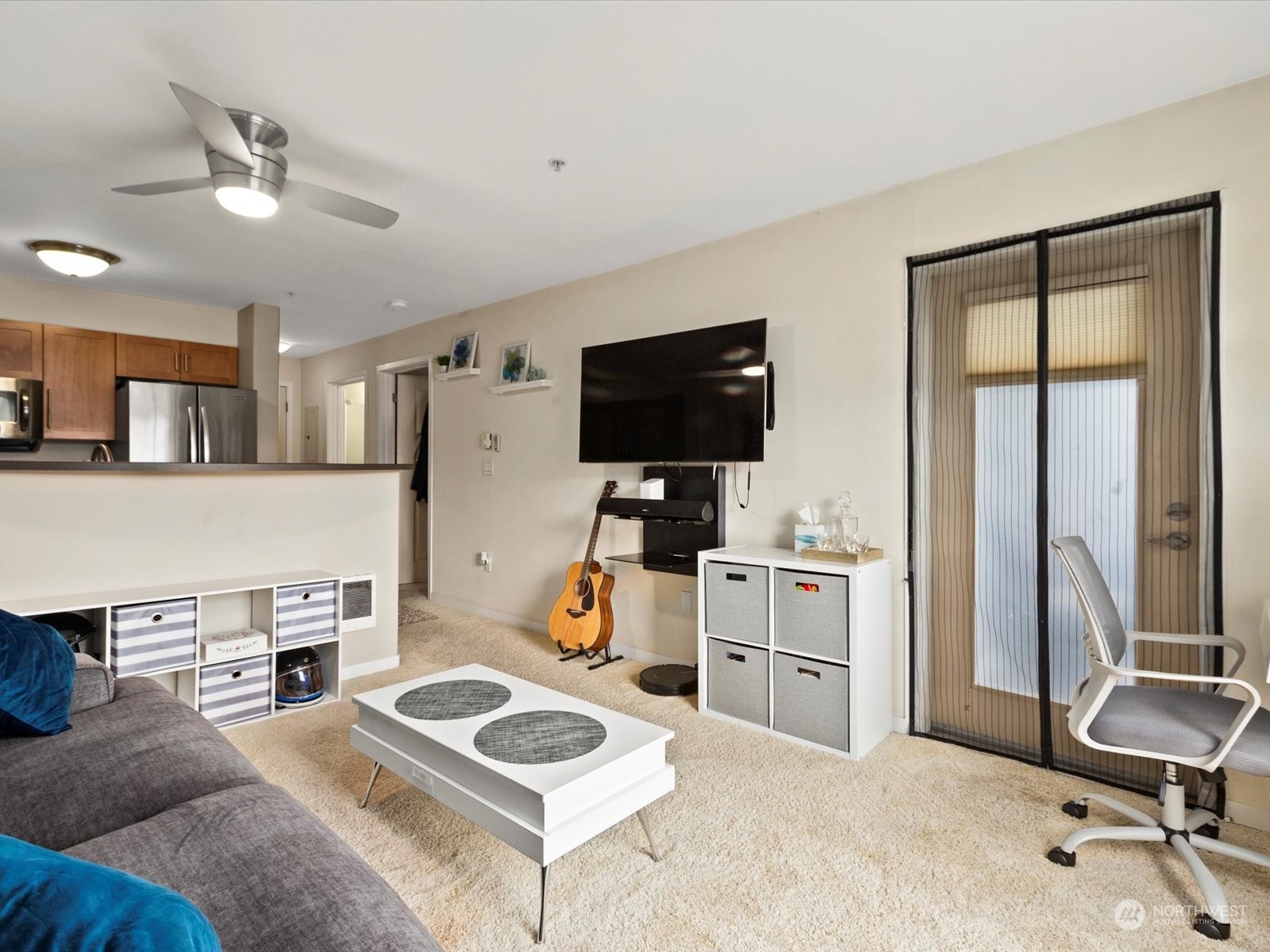 3015 Southwest Avalon Way, Unit 407 Seattle, WA 98126 - Photo 4 of 27 a living room with furniture and a flat screen tv