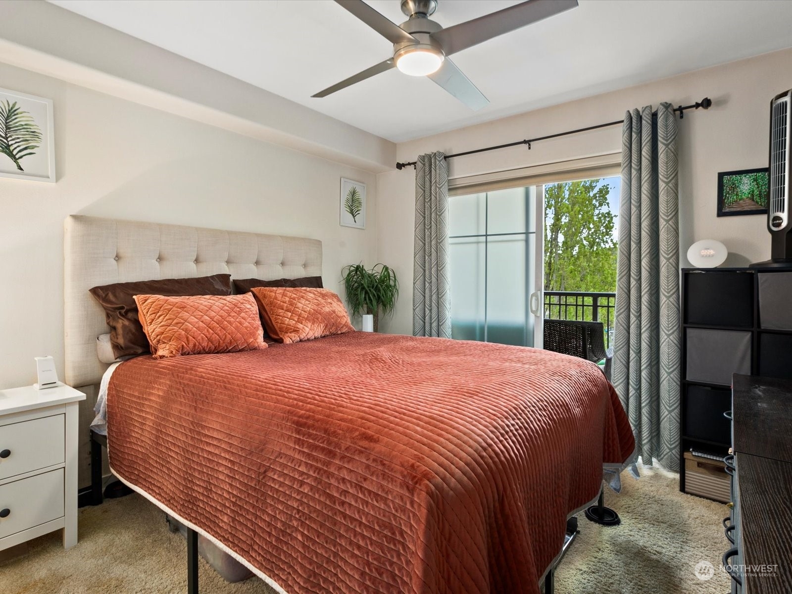 3015 Southwest Avalon Way, Unit 407 Seattle, WA 98126 - Photo 5 of 27 a large bed sitting in a bedroom next to a window