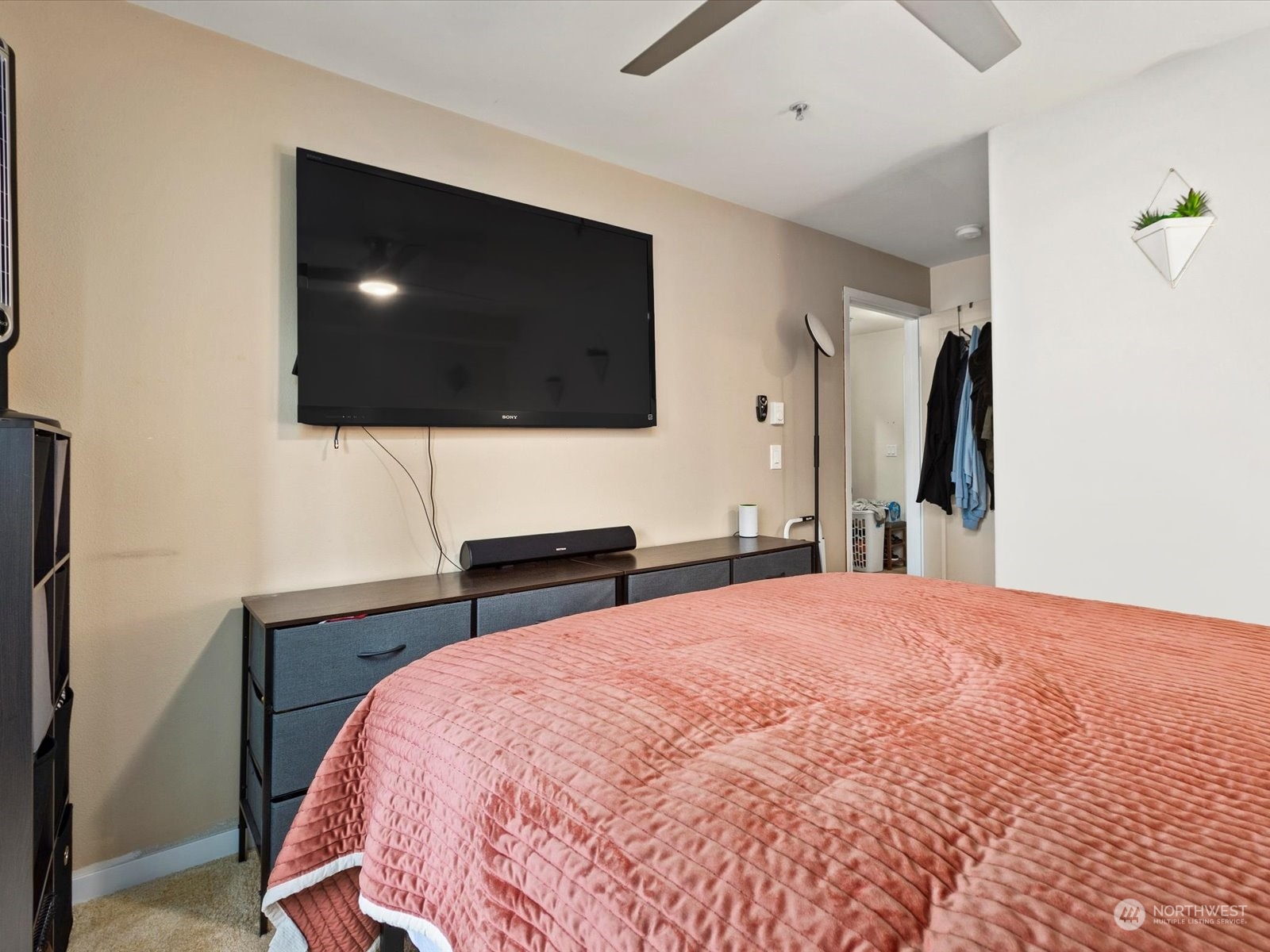 3015 Southwest Avalon Way, Unit 407 Seattle, WA 98126 - Photo 6 of 27 a bedroom with a bed and a flat screen tv