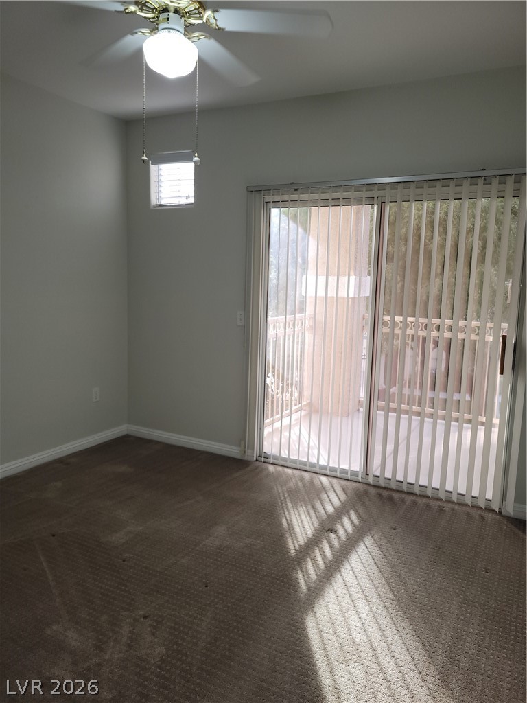 8555 West Russell Road, Unit 2094 Las Vegas, NV 89113 - Photo 13 of 31 Carpeted primary bedroom with ceiling fan and light