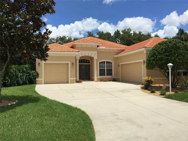a view of a white house with a yard