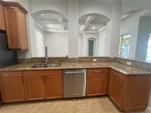 a bathroom with a granite countertop sink a large mirror and a window