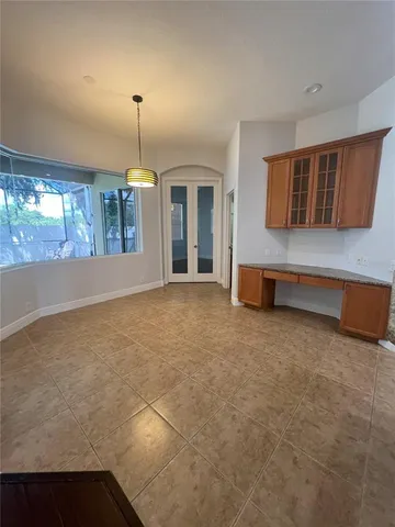 a view of a livingroom with a ceiling fan and window