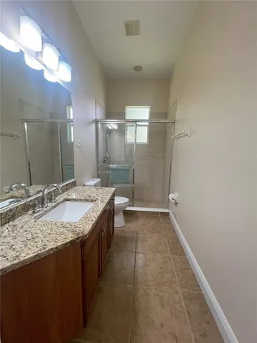 a view of a room with wooden floor and windows
