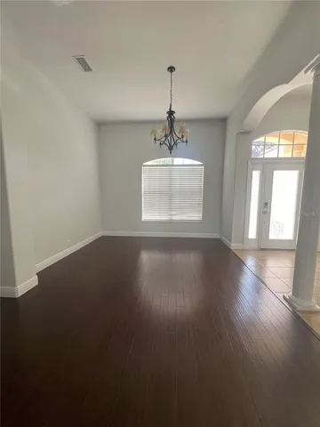 a view of wooden floor and windows in a room