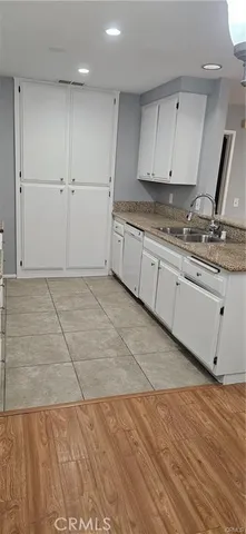 a kitchen with granite countertop a stove a sink and a granite counter tops