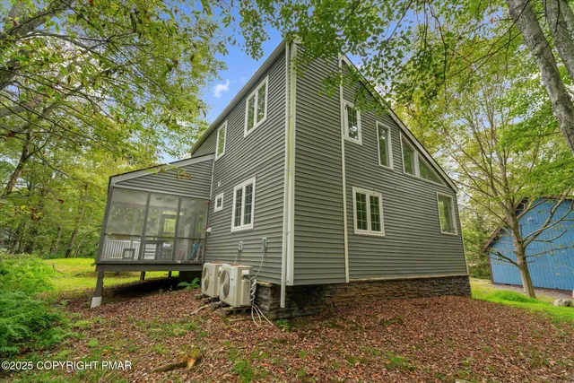 a view of a house with pool and sitting area