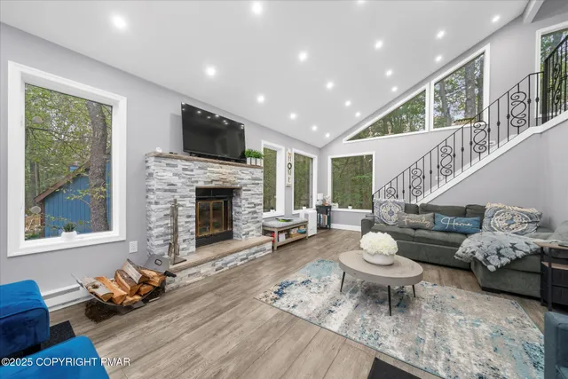 a living room with furniture and a fireplace