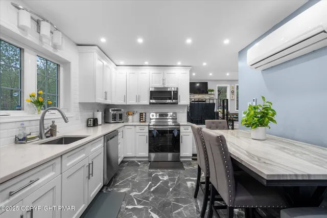 a kitchen with a table chairs sink and cabinets