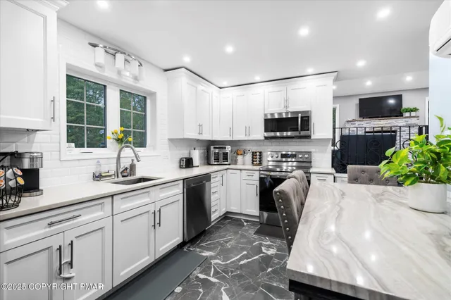 a kitchen with a sink a stove and cabinets