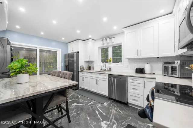 a kitchen with sink cabinets and dining table chair
