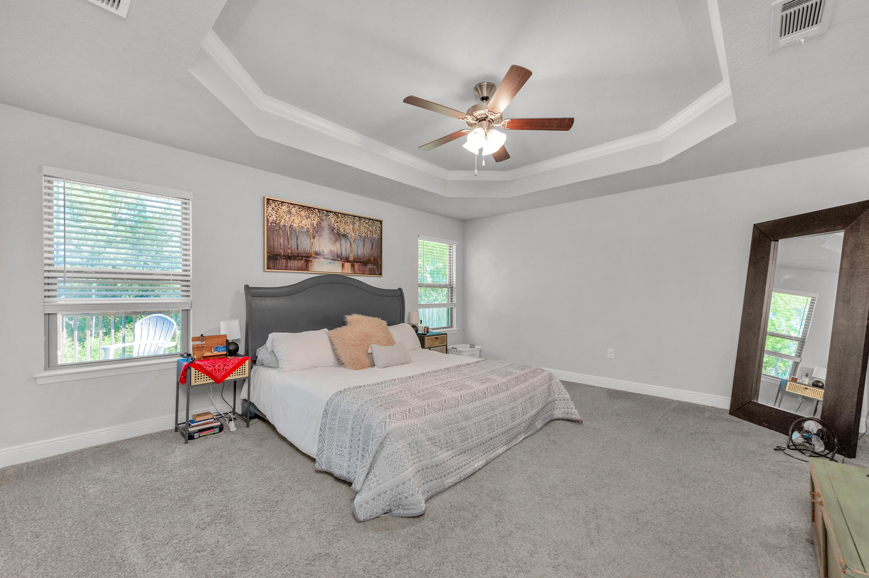 306 Vale Loop Crestview, FL 32536 - Photo 18 of 40 a bedroom with a bed next to a window and a flat screen tv