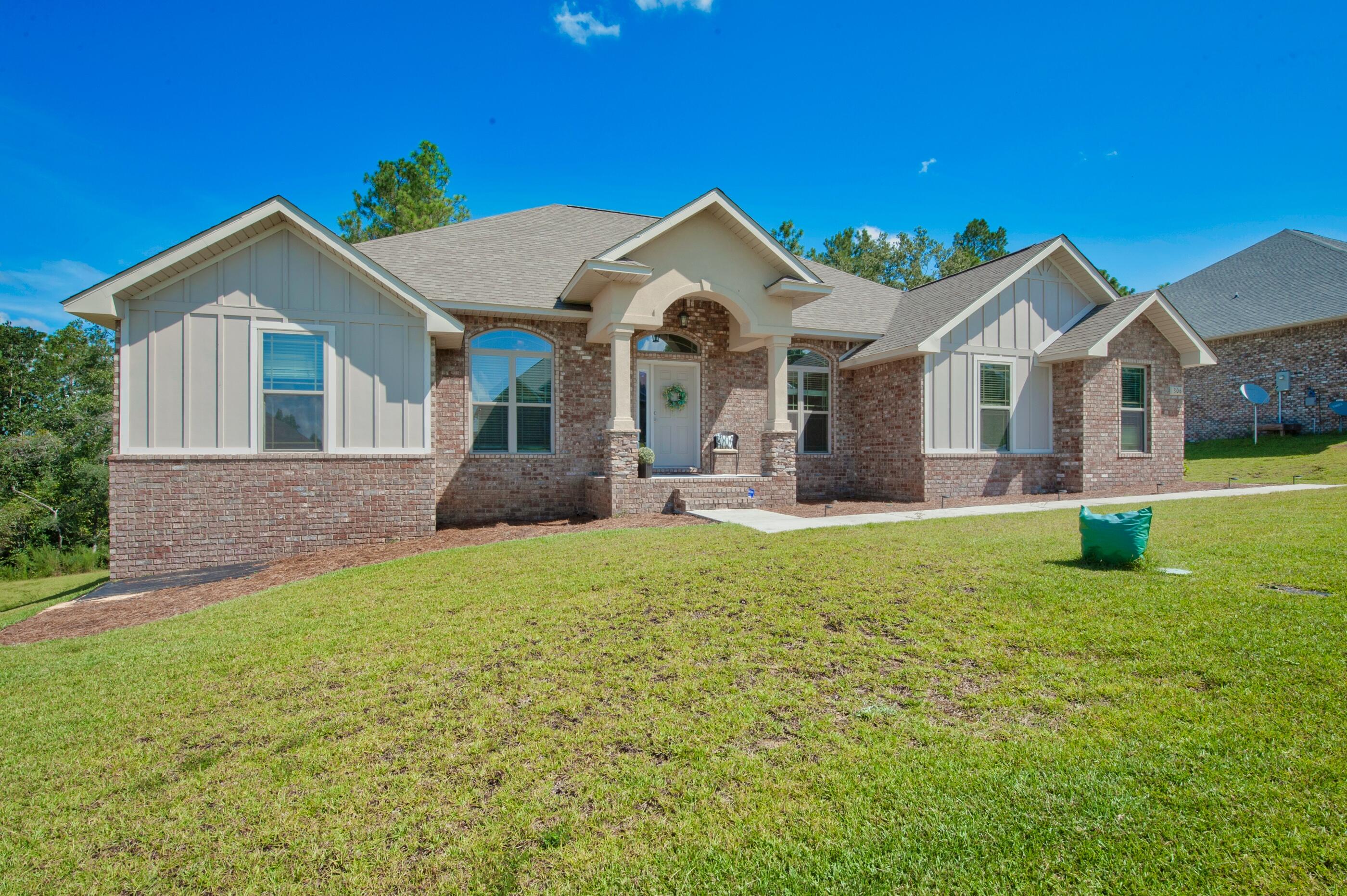 306 Vale Loop Crestview, FL 32536 - Photo 2 of 40 a front view of a house with a yard