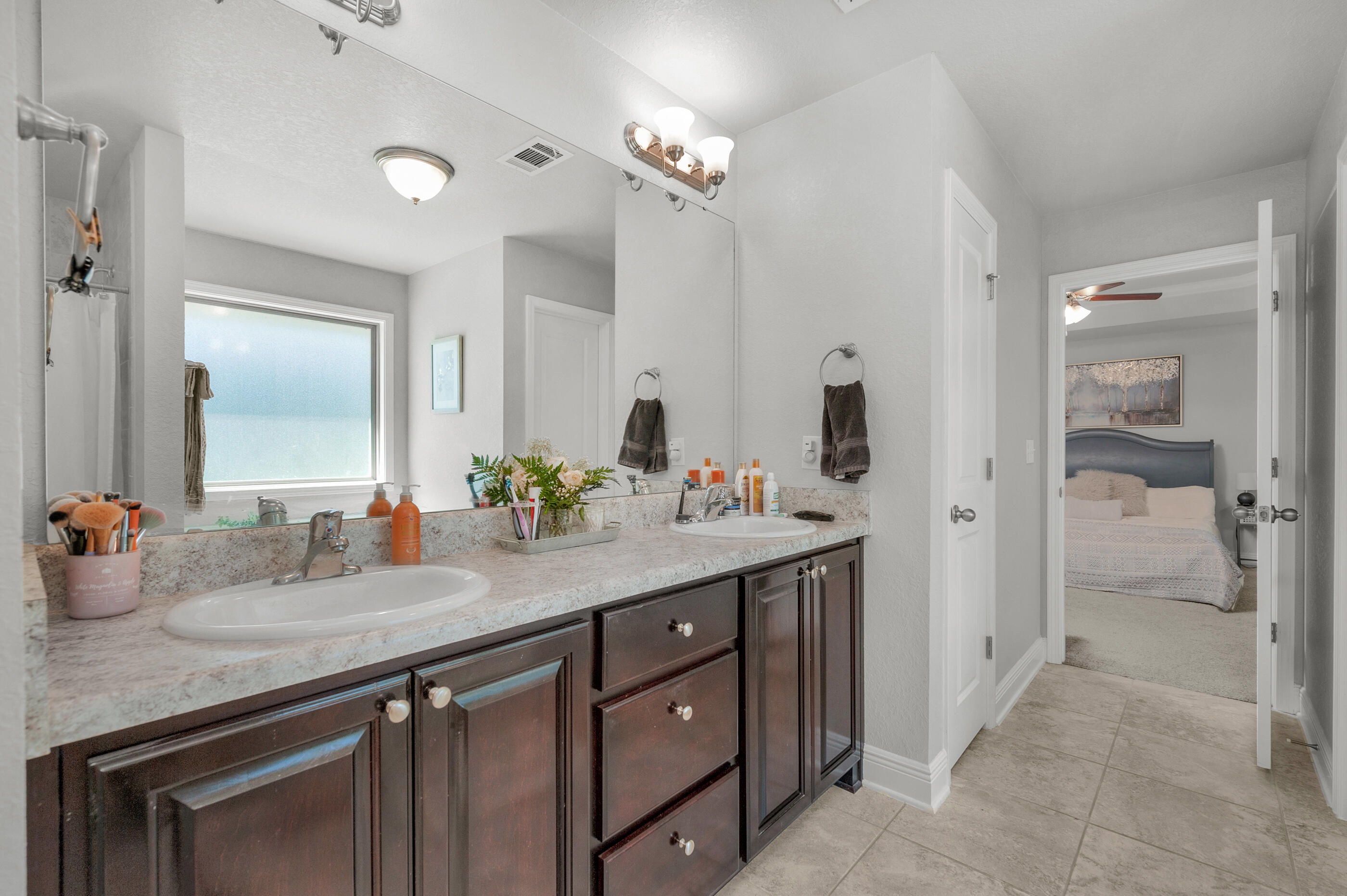 306 Vale Loop Crestview, FL 32536 - Photo 21 of 40 a bathroom with a granite countertop sink and a mirror