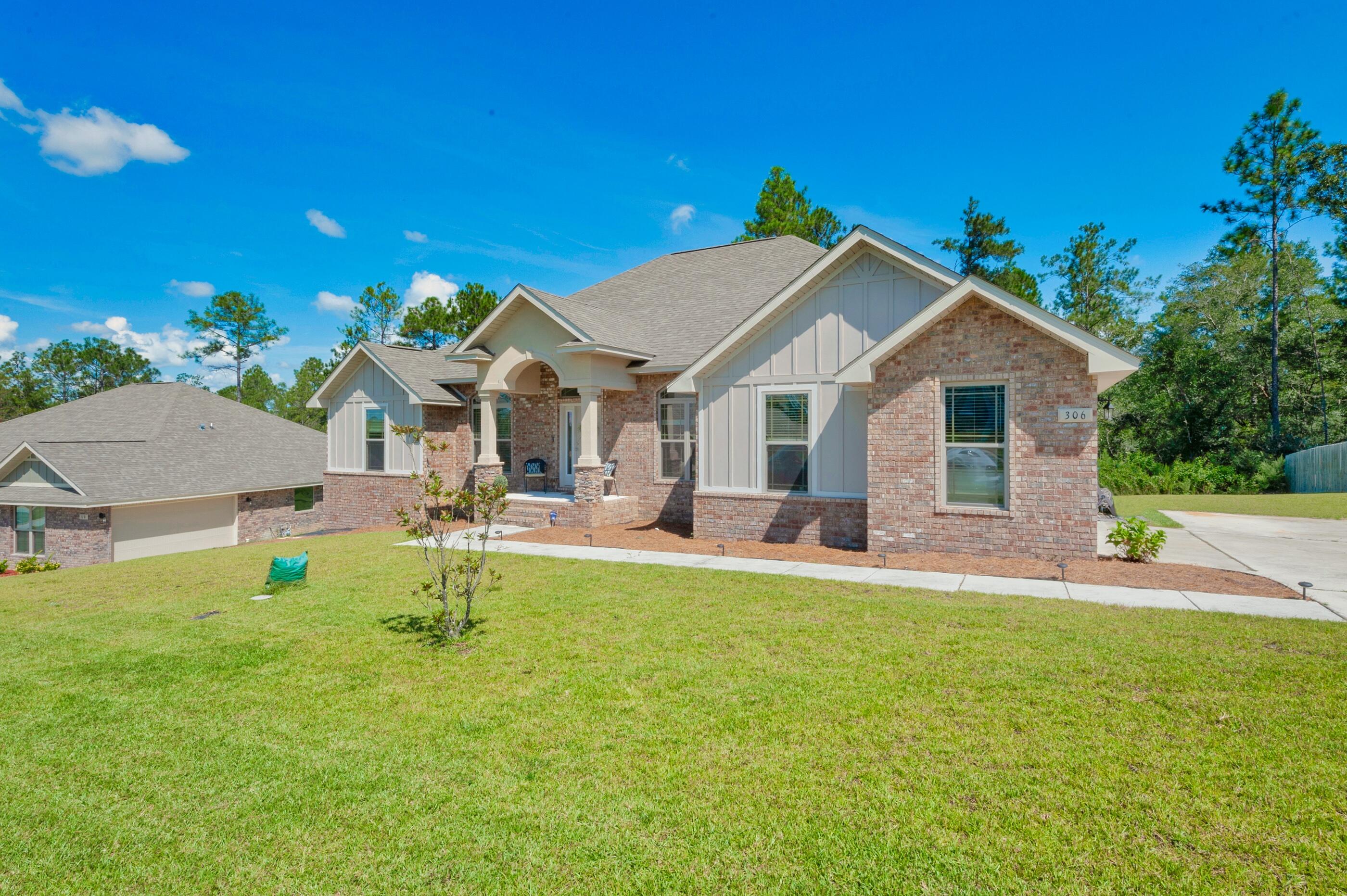 306 Vale Loop Crestview, FL 32536 - Photo 3 of 40 a house view with a sitting space and garden
