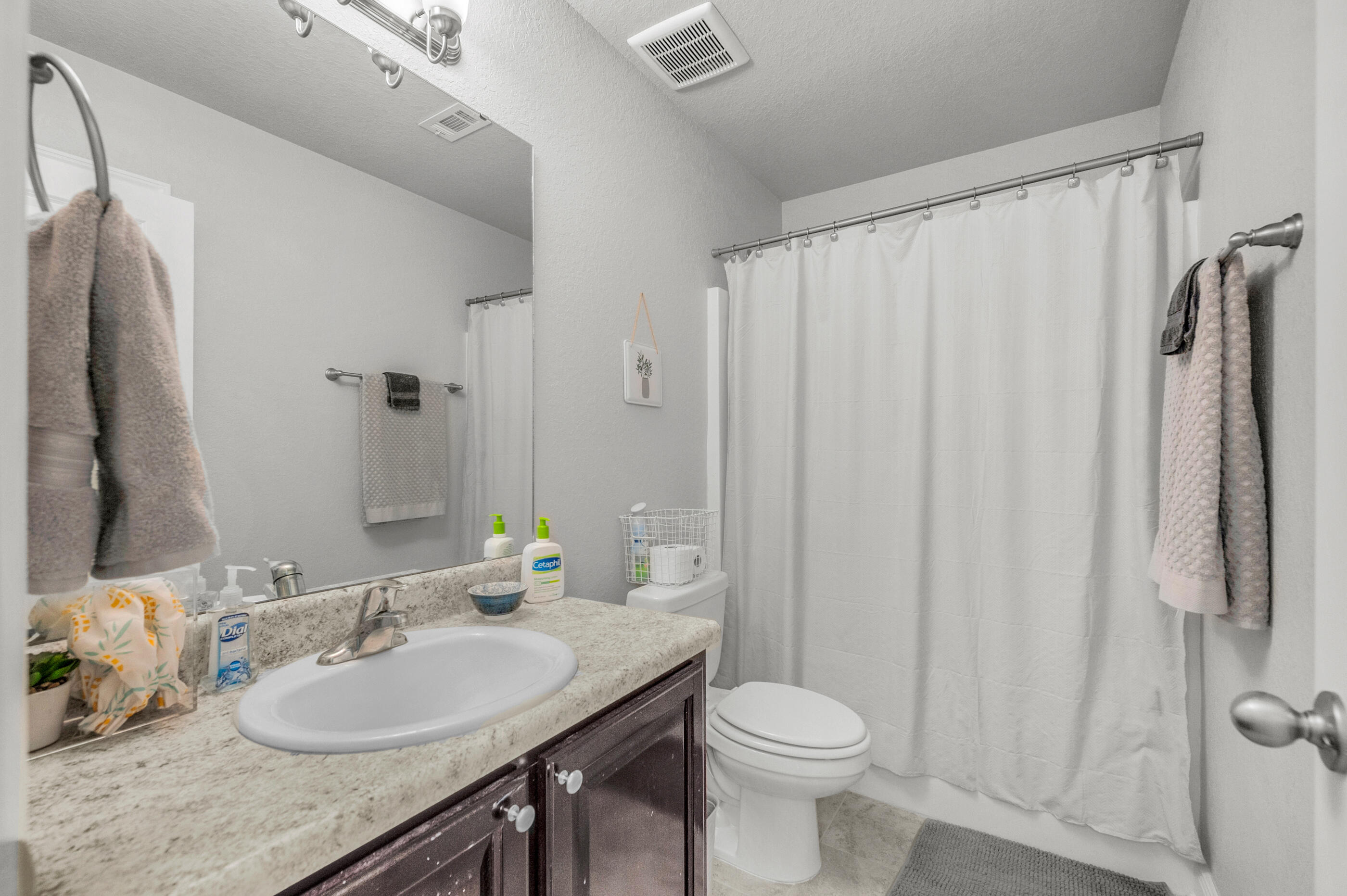 306 Vale Loop Crestview, FL 32536 - Photo 32 of 40 a bathroom with a granite countertop sink toilet and shower