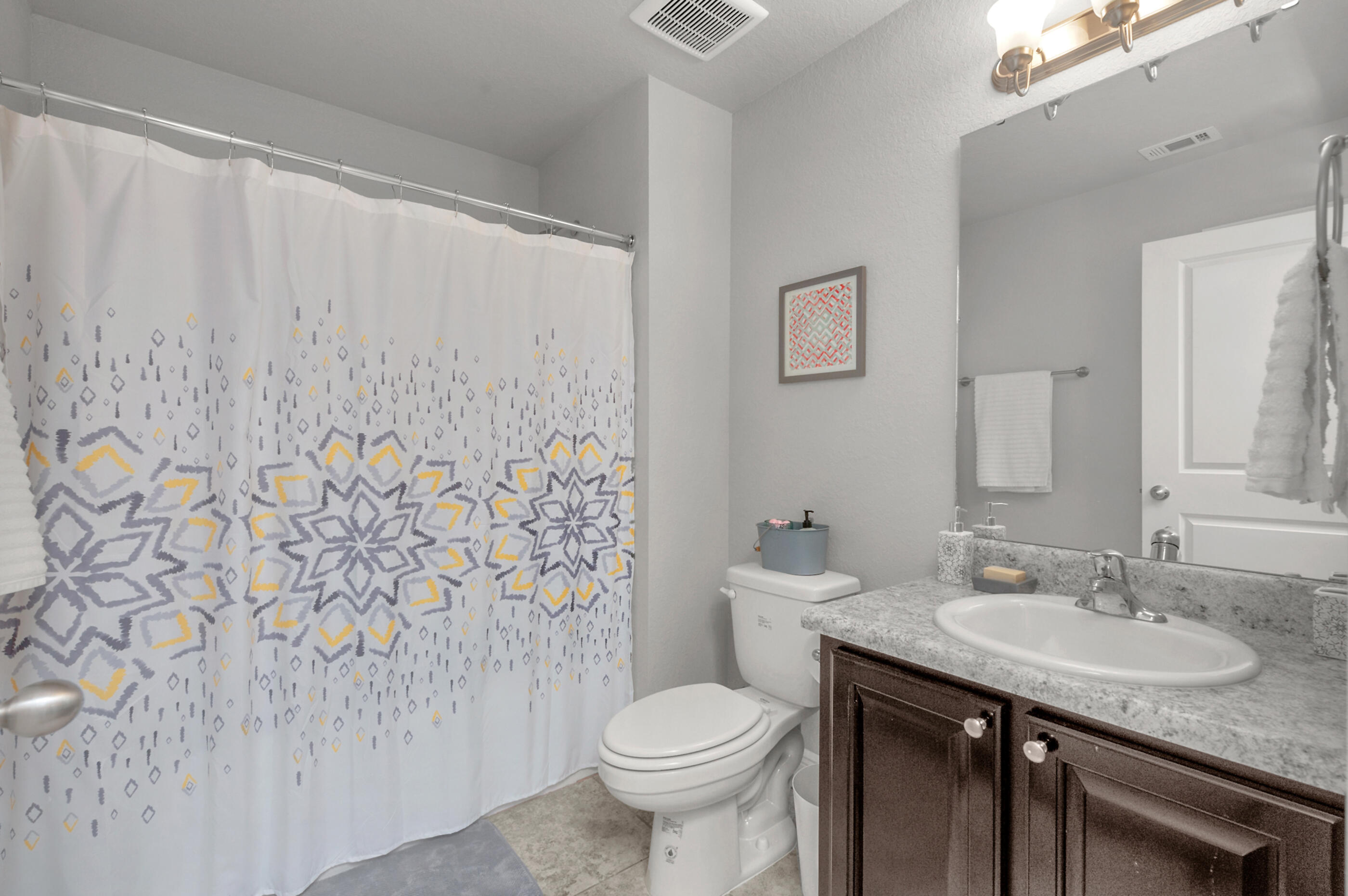 306 Vale Loop Crestview, FL 32536 - Photo 33 of 40 a bathroom with a granite countertop sink toilet and a mirror